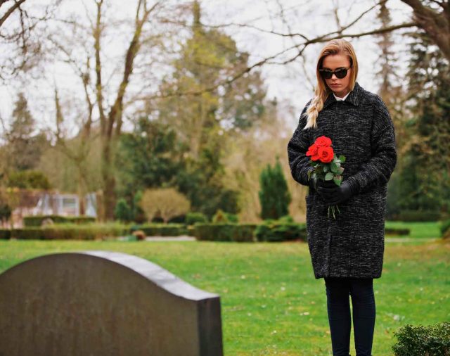 Woman Before Gravestone mourning death of a husband