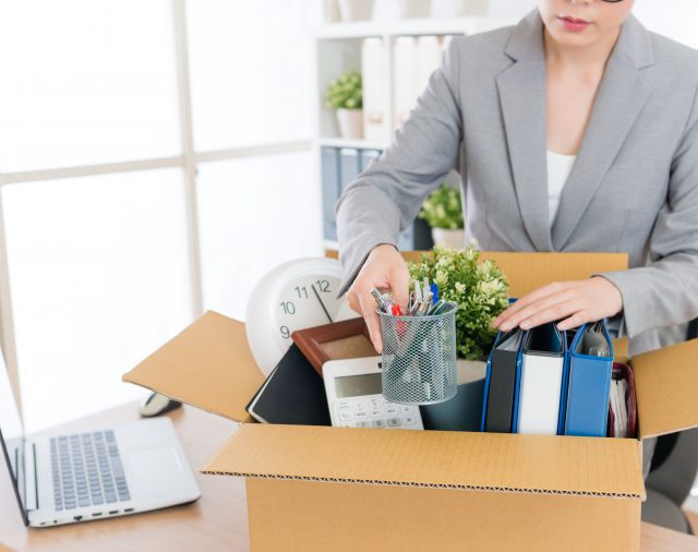 Business woman packing after downsizing & grief