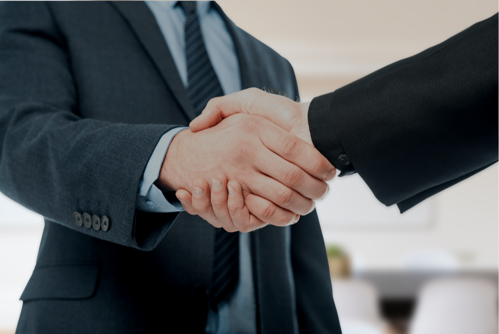 two men shaking hands on first day of work